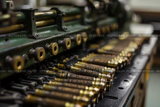 Vintage printing press holding metal type pieces for traditional typography. Стоковое AI-изображение, AI-художник Иван Рябоконь / Фотобанк Лори