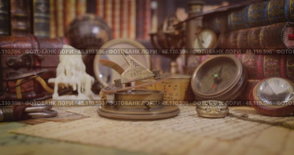 Vintage style travel and adventure. Vintage old compass and other vintage items on the table. Стоковое видео, видеограф Андрей Армягов / Фотобанк Лори