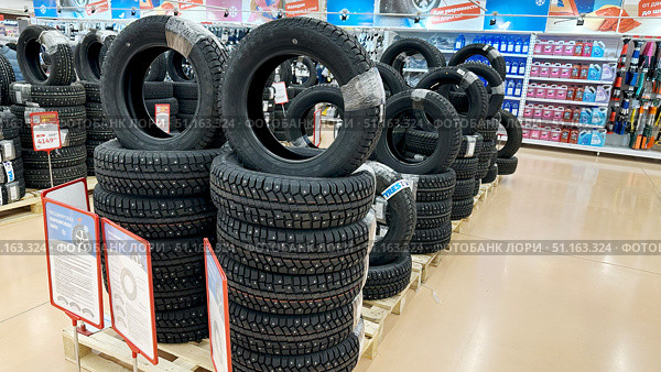 Vladimir, Russia, July 24, 2025: Winter tires at Auchan hypermarket. Редакционное фото, фотограф Igor Skripachev / Фотобанк Лори