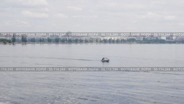 Voronezh, Russia, June 17, 2025: City of Voronezh near the reservoir, view from Petrovskaya embankment, floating boat. Стоковое видео, видеограф Катерина Белякина / Фотобанк Лори