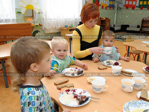 Воспитатель кормит детей в ясельной группе (2010 год). Редакционное фото, фотограф Вячеслав Палес / Фотобанк Лори