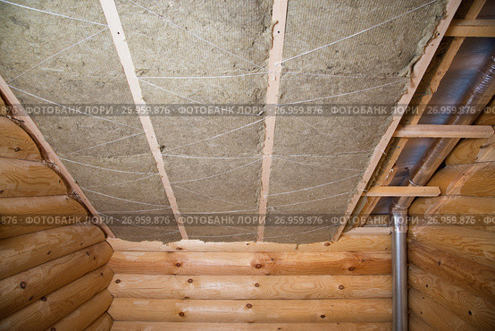 Wall heat isolation with mineral wool in wooden house, building under construction. Стоковое фото, фотограф Сергей Дорошенко / Фотобанк Лори
