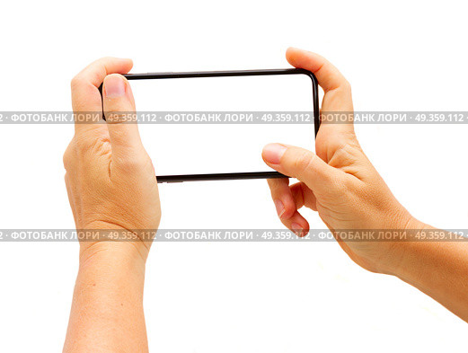 WARSAW, POLAND - DECEMBER 02, 2017: Two hands holding new Iphone X mobile phone over white background. New Iphone X. New Iphone X. Редакционное фото, агентство Ingram Publishing / Фотобанк Лори