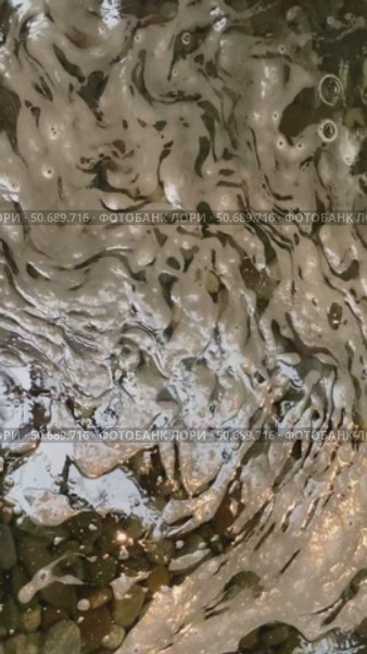 Water surface with bubbles and ripples creating abstract background pattern and texture. Стоковое видео, видеограф Анастасия Золотницкая / Фотобанк Лори