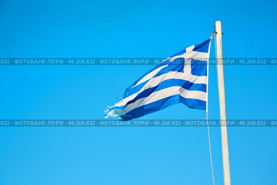 waving greece flag  in the blue sky and      flagpole. Стоковое фото, агентство Ingram Publishing / Фотобанк Лори