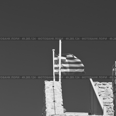 waving greece flag  in the   blue sky and      flagpole. Стоковое фото, агентство Ingram Publishing / Фотобанк Лори
