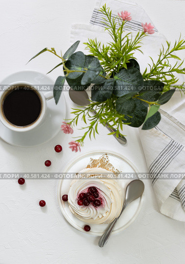 White cup with black coffee and Pavlov's cake on a light table. Стоковое фото, фотограф Анна Никитина / Фотобанк Лори