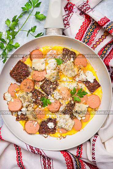 White frypan with egg omelette with sausage, bread and cheese, top view, close up. Стоковое фото, агентство Ingram Publishing / Фотобанк Лори