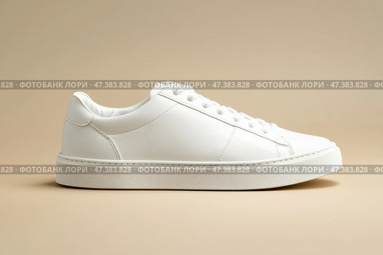 White leather lace-up running shoes with low tops, thick soles on a beige. The laces and rubber outsole. Sporty look. Men to wear during outdoor activities. Street hiking shoes. Trendy Male Boots Pair. Стоковое AI-изображение, AI-художник Марина Демидюк / Фотобанк Лори