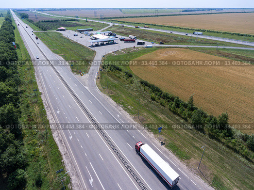 White semi trailer truck driving on straight highway to pertol station. view from above. The Don M4 route in Russia. Стоковое фото, фотограф Кекяляйнен Андрей / Фотобанк Лори
