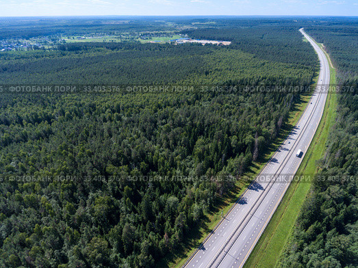 Wide straight toll highway M-11 passing in forests. View from above. The Moscow-Saint Petersburg motorway designed as the M11 Neva is in Russia. Стоковое фото, фотограф Кекяляйнен Андрей / Фотобанк Лори