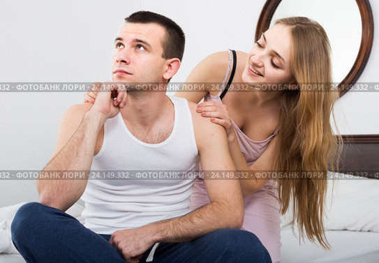 wife warmly comforting upset husband in bedroom. Стоковое фото, фотограф Яков Филимонов / Фотобанк Лори