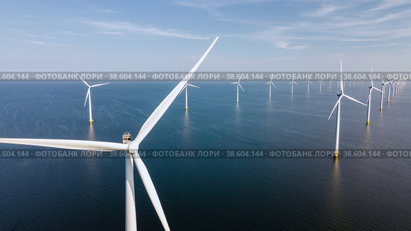 Wind turbine from aerial view, Drone view at windpark westermeerdijk a windmill farm in the lake IJsselmeer the biggest in the Netherlands,Sustainable development, renewable energy. Стоковое фото, фотограф Fokke Baarssen / Фотобанк Лори