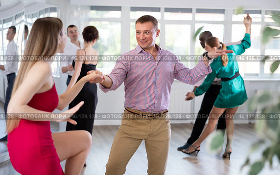 Woman dances incendiary boogie woogie with man partner during choreography lesson. Стоковое фото, фотограф Яков Филимонов / Фотобанк Лори