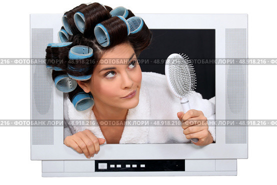 Woman escaping from television. Стоковое фото, агентство Ingram Publishing / Фотобанк Лори