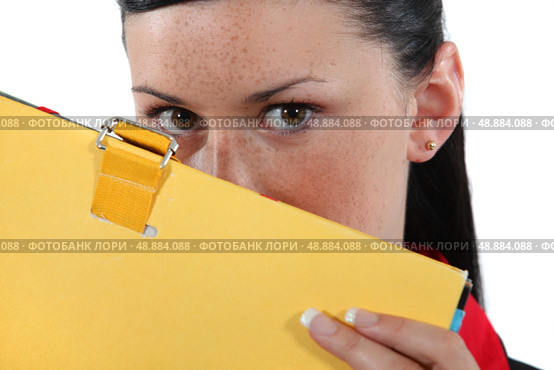Woman hiding behind a folder. Стоковое фото, агентство Ingram Publishing / Фотобанк Лори