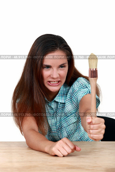 Woman holding a paintbrush. Стоковое фото, агентство Ingram Publishing / Фотобанк Лори