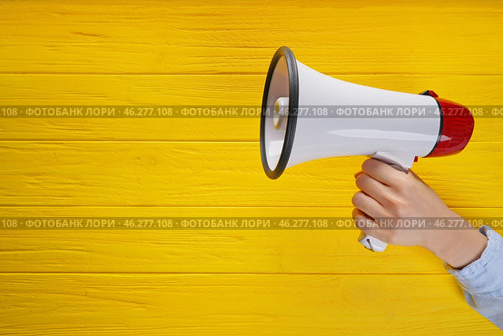 Woman holding megaphone on color wooden background. Стоковое фото, фотограф Pixel_shot / Фотобанк Лори