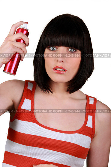 Woman spraying hair lacquer. Стоковое фото, фотограф Phovoir Images / Фотобанк Лори
