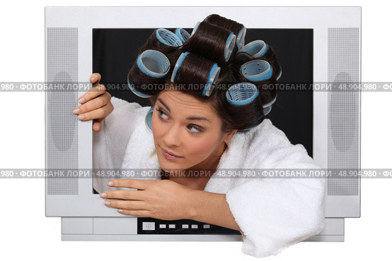 Woman wearing hair rollers escaping from television. Стоковое фото, агентство Ingram Publishing / Фотобанк Лори