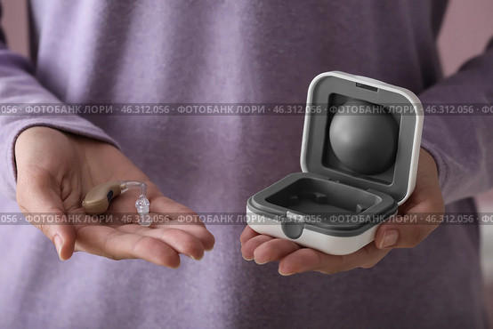 Woman with hearing aid and box, closeup. Стоковое фото, фотограф Pixel_shot / Фотобанк Лори