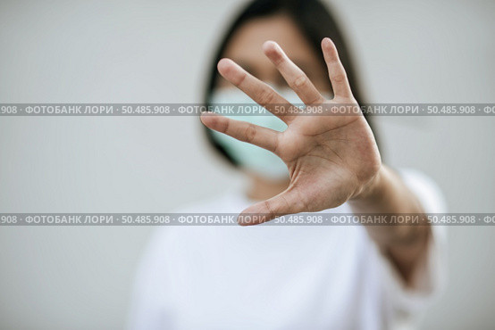 Women wear masks and forbid by raising their hands in front. Стоковое фото, агентство Ingram Publishing / Фотобанк Лори