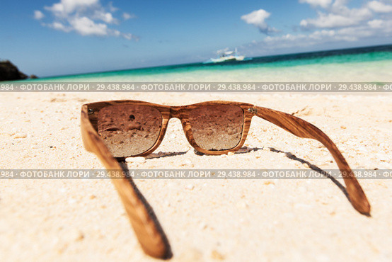 wooden sunglasses lying on the beach. Стоковое фото, фотограф Иван Михайлов / Фотобанк Лори