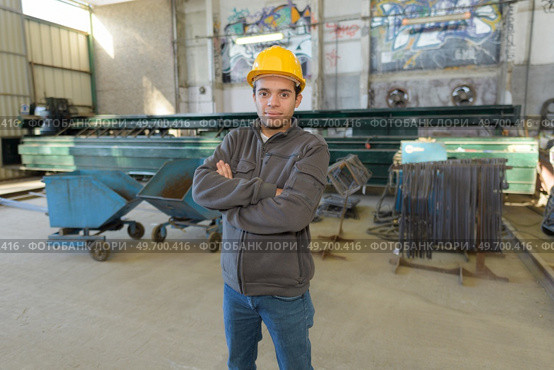 worker in work clothes with yellow helmet in factory. Стоковое фото, агентство Ingram Publishing / Фотобанк Лори