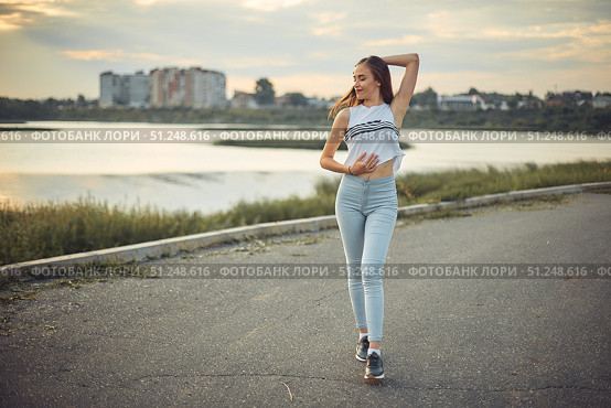 Young beautiful caucasian blonde girl listening to music with smartphone walking and dance in the city with headphones smiling - relax, youth, emancipation concept. Стоковое фото, фотограф Арзюков Вадим Николаевич / Фотобанк Лори
