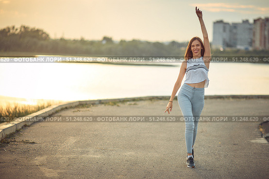 Young beautiful caucasian blonde girl listening to music with smartphone walking and dance in the city with headphones smiling - relax, youth, emancipation concept. Стоковое фото, фотограф Арзюков Вадим Николаевич / Фотобанк Лори