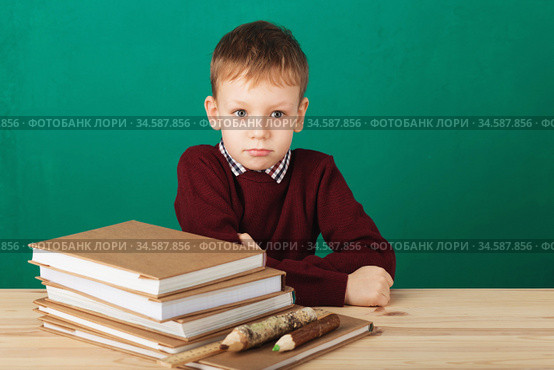 Young boy looking angry shaking his fists tired of school lessons, education. Tiredness stressing overworking children expressive emotional furious mad learning. Back to School. Стоковое фото, фотограф Nataliia Zhekova / Фотобанк Лори