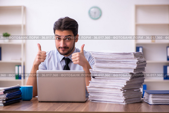 Young businessman employee unhappy with excessive work in the office. Стоковое фото, фотограф Elnur / Фотобанк Лори