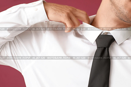Young businessman in tight shirt on color background, closeup. Стоковое фото, фотограф Pixel_shot / Фотобанк Лори