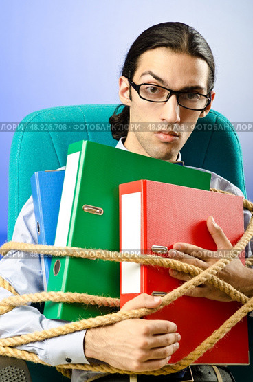 Young businessman tied with rope. Стоковое фото, агентство Ingram Publishing / Фотобанк Лори