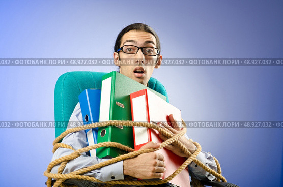 Young businessman tied with rope. Стоковое фото, агентство Ingram Publishing / Фотобанк Лори