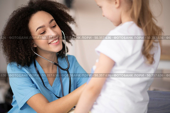 young doctor making sure little girl is fine after vaccination. Стоковое фото, агентство Ingram Publishing / Фотобанк Лори
