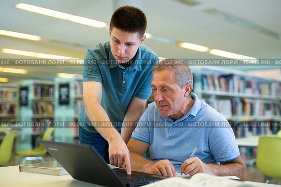 Young European man tutoring a mature Caucasian male. Стоковое фото, фотограф Яков Филимонов / Фотобанк Лори
