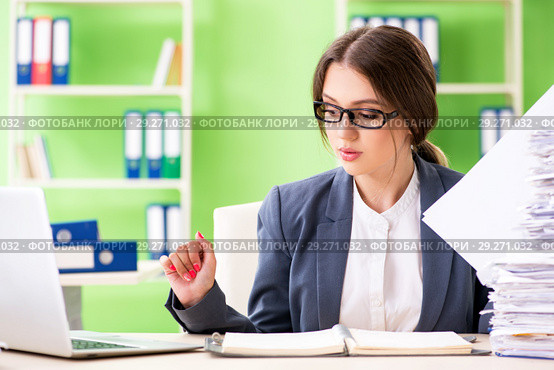 Young female employee very busy with ongoing paperwork. Стоковое фото, фотограф Elnur / Фотобанк Лори