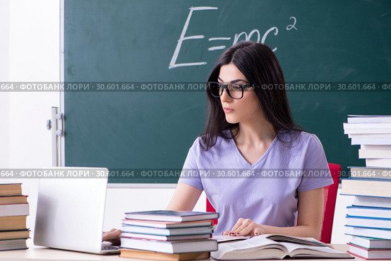 Young female teacher student in front of green board. Стоковое фото, фотограф Elnur / Фотобанк Лори