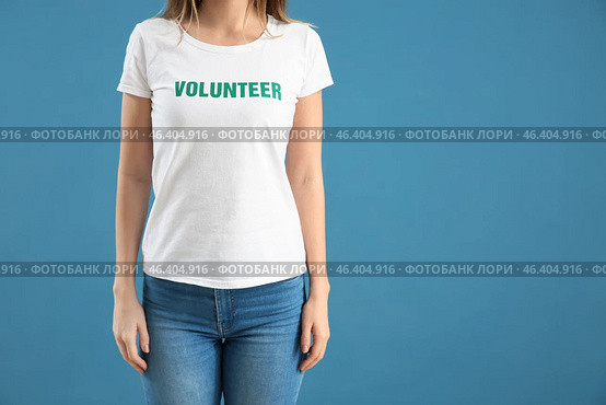 Young female volunteer on color background. Стоковое фото, фотограф Pixel_shot / Фотобанк Лори