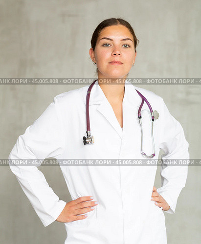 Young focused female doctor standing with pride. Стоковое фото, фотограф Яков Филимонов / Фотобанк Лори