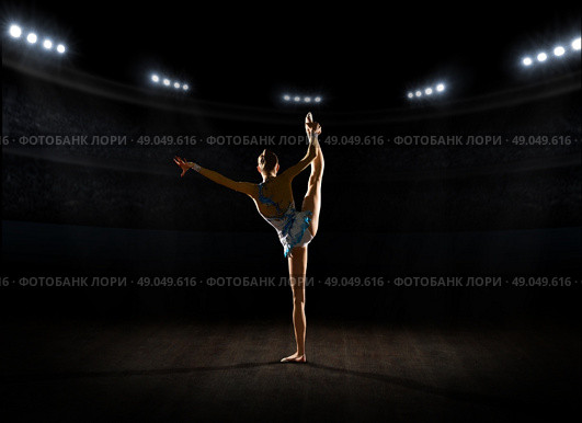 Young girl engaged art gymnastic at sports hall. Стоковое фото, агентство Ingram Publishing / Фотобанк Лори