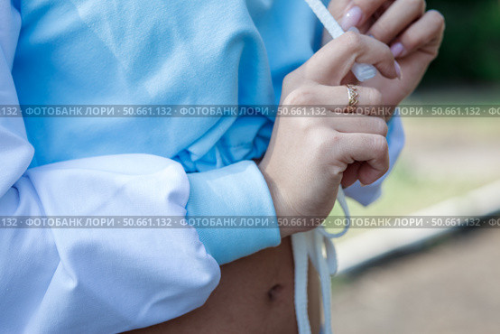 Young girl in sports blue hoodie outdoors. close-up of the hands. Стоковое фото, фотограф Роготнева Виктория / Фотобанк Лори