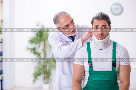 Young male contractor visiting old doctor. Стоковое фото, фотограф Elnur / Фотобанк Лори