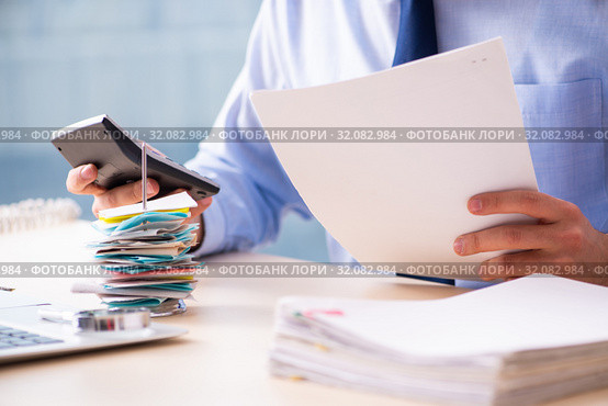 Young male employee in budget planning concept. Стоковое фото, фотограф Elnur / Фотобанк Лори