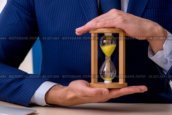 Young male employee in time management concept. Стоковое фото, фотограф Elnur / Фотобанк Лори