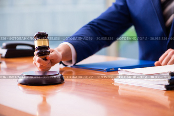 Young male judge sitting in courtroom. Стоковое фото, фотограф Elnur / Фотобанк Лори
