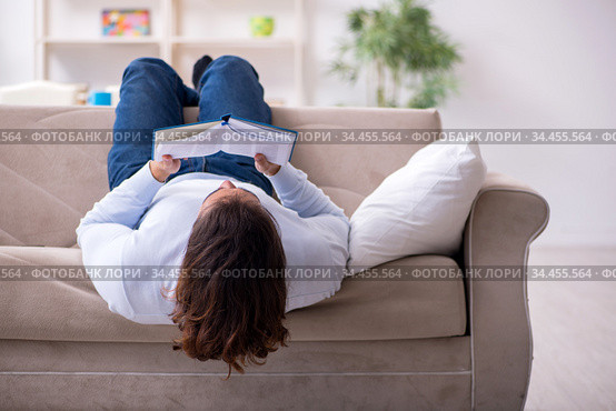 Young male student preparing for exams at home. Стоковое фото, фотограф Elnur / Фотобанк Лори