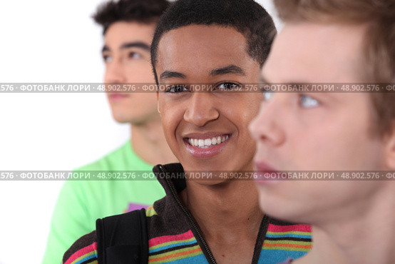Young man surrounded by his peers. Стоковое фото, агентство Ingram Publishing / Фотобанк Лори