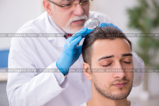Young man visiting experienced doctor dermatologist. Стоковое фото, фотограф Elnur / Фотобанк Лори